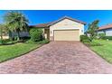 House exterior showcasing a brick driveway and lush landscaping at 6512 Willowshire Way, Bradenton, FL 34212