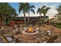 Relaxing fire pit area with comfortable seating in the backyard at 654 Trenton Way, Osprey, FL 34229