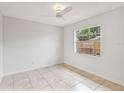 Simple bedroom with tile flooring and a window with blinds at 6770 Mauna Loa Blvd, Sarasota, FL 34241