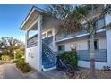 Front view of a two-story building with stairs and bicycle at 6800 Placida Rd # 2017, Englewood, FL 34224