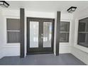 Modern front entrance with double doors and updated flooring at 7 Oakland Hills Pl, Rotonda West, FL 33947