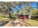 Home's exterior showcasing a carport and large trees at 729 41St St, Sarasota, FL 34234