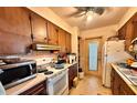 Small kitchen with wood cabinets and appliances at 729 41St St, Sarasota, FL 34234