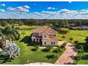 Two-story house on a golf course with a pond nearby at 7315 Bianco Duck Ct, Sarasota, FL 34240