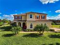 Two-story house with red shutters, tile roof, and landscaping at 7315 Bianco Duck Ct, Sarasota, FL 34240