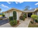 House exterior showcasing landscaping and double doors at 7460 W Country Club N Dr, Sarasota, FL 34243