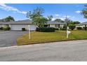 Front yard view of the house with a well-maintained lawn at 7460 W Country Club N Dr, Sarasota, FL 34243