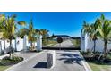 Gated community entrance with palm trees and landscaped medians at 8005 20Th W Pl, Bradenton, FL 34209