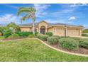 Well-maintained tan house with attractive landscaping and two-car garage at 9100 Yarberry St, Sarasota, FL 34240