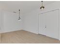 Empty dining room with light wood floors and modern light fixture at 9100 Yarberry St, Sarasota, FL 34240