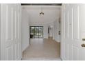 Bright and airy entryway with light wood floors and views into the living area at 9100 Yarberry St, Sarasota, FL 34240