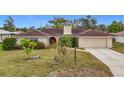 Single-story house with red front door and tile roof at 121 Van Dyck Dr, Nokomis, FL 34275