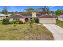 Single story house with red front door, tile roof, and palm trees at 121 Van Dyck Dr # Dr, Nokomis, FL 34275