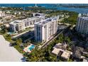 Aerial view of condo building near beach and water at 1212 Benjamin Franklin Dr # 305, Sarasota, FL 34236