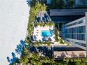 Overhead view of resort-style pool with lounge chairs and palm trees at 1212 Benjamin Franklin Dr # 305, Sarasota, FL 34236