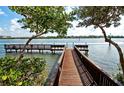 Private wooden dock with benches, offering serene waterfront views at 1260 Dolphin Bay Way # 303, Sarasota, FL 34242