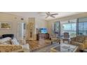 Spacious living room, featuring hardwood floors and water views at 1260 Dolphin Bay Way # 303, Sarasota, FL 34242