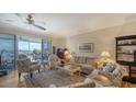 Bright living room with water views and comfy seating at 1260 Dolphin Bay Way # 303, Sarasota, FL 34242