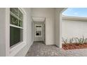 Front entry with tiled floor and access to laundry room at 12649 Palatka Dr, Venice, FL 34293