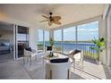 Bright sunroom with water views and comfy seating at 1280 Dolphin Bay Way # 202, Sarasota, FL 34242