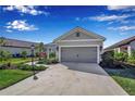 Gray house with two-car garage and landscaping at 12915 True Blue Cir, Bradenton, FL 34211