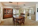 Dining room with kitchen view, wooden table and chairs, and a built-in hutch at 1314 64Th W St, Bradenton, FL 34209