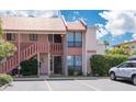 Exterior view of condo building with parking and landscaping at 1801 Gulf N Dr # 175, Bradenton Beach, FL 34217