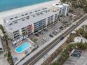 Aerial view showing condo building and beachfront location at 19610 Gulf Blvd # 303, Indian Shores, FL 33785