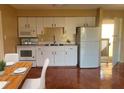 Condo kitchen with white cabinets and appliances at 2636 Hidden Lake N Dr # G, Sarasota, FL 34237