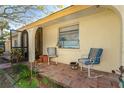 Relaxing front porch with terracotta tile and two chairs at 315 Palm Grove Ave, Englewood, FL 34223