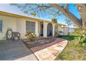 Inviting front porch with terracotta tile flooring and seating area at 315 Palm Grove Ave, Englewood, FL 34223