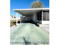 Covered carport with green concrete pavement at 3411 Spanish Oak Ter, Sarasota, FL 34237