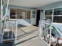 Covered porch with white railing and access to the mobile home at 3710 Gulf Of Mexico Dr # G-6, Longboat Key, FL 34228