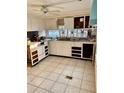 Small kitchen with white cabinets and appliances needing updating at 3710 Gulf Of Mexico Dr # G-6, Longboat Key, FL 34228