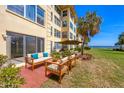 A furnished patio offers a relaxing outdoor space with serene waterfront views at 3810 Gulf Of Mexico Dr # F105, Longboat Key, FL 34228