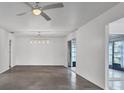 Open dining area with concrete floors and modern light fixture at 3904 Lakeside Rd # 174, Sarasota, FL 34232