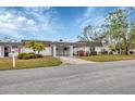 Front view of a condo with landscaping and driveway at 3904 Lakeside Rd # 174, Sarasota, FL 34232