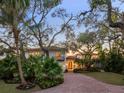 Stunning two-story home with a brick driveway, lush landscaping, and a Mediterranean style at 3930 Red Rock Way, Sarasota, FL 34231