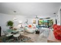 Bright living room with white sectional sofa, glass dining table, and view of the patio at 401 Spring Lakes Blvd # 401, Bradenton, FL 34210