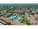 Aerial view of a community with condos, pool, tennis courts, and lush landscaping at 4250 Players Pl # 2625, Sarasota, FL 34238