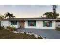 Newly renovated single story home with teal shutters and landscaping at 4609 19Th W St, Bradenton, FL 34207