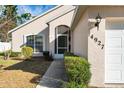 Front entrance with walkway, landscaping, and screened door at 4927 69Th E Ct, Palmetto, FL 34221