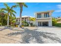 Two-story house with a modern design, two-car garage, and landscaped yard at 505 69Th St, Holmes Beach, FL 34217