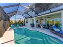 Inviting swimming pool with screened enclosure and comfortable lounge area at 5204 Title Row Dr, Bradenton, FL 34210