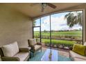 Relaxing screened porch with wicker furniture overlooking the golf course at 5517 Palmer Cir # 101, Bradenton, FL 34211