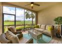 Cozy screened-in patio with wicker furniture and golf course view at 5517 Palmer Cir # 101, Bradenton, FL 34211