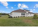 Spacious backyard with lush grass and a view of a pond at 5564 Coachwood Cv, Bradenton, FL 34211