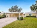 Cute yellow home with carport and nicely landscaped yard at 5936 Driftwood Ave # 16, Sarasota, FL 34231