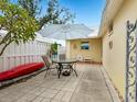 Relaxing patio with table, chairs, and umbrella; kayak for storage at 5936 Driftwood Ave # 16, Sarasota, FL 34231