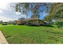 Single story house with lush green lawn at 601 Lakescene Dr, Venice, FL 34293